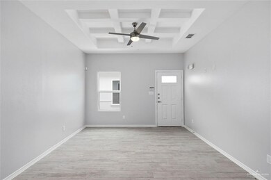 Empty room featuring baseboards, visible vents, a healthy amount of sunlight, and light wood finished floors