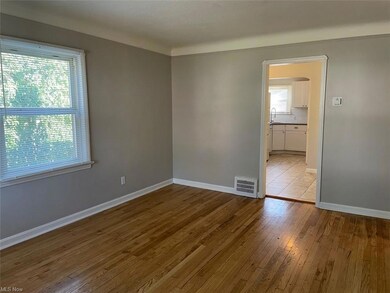 Spare room with plenty of natural light and light hardwood floors