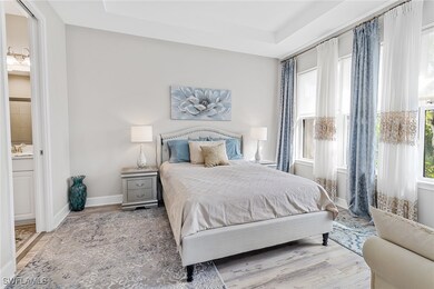 Bedroom featuring light wood-type flooring, a rais
