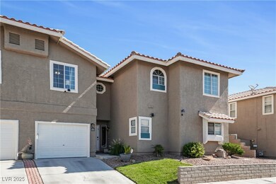 View of front of house with stucco siding, an atta