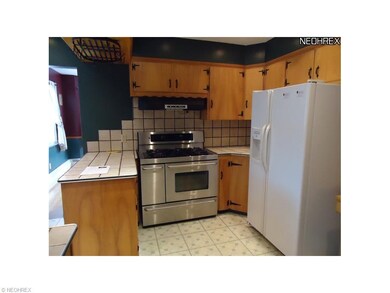 Kitchen with gas range and tiled backsplash.