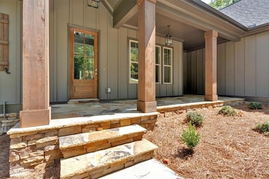 Welcoming front entrance features handsome flagsto