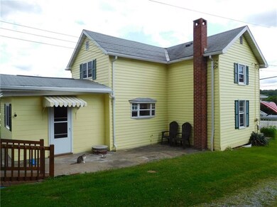Side view shows large porch area and garden window