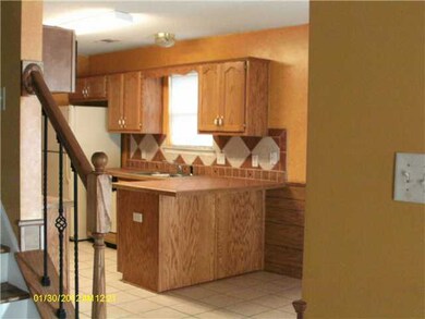 View of kitchen from living room. Notice tile work