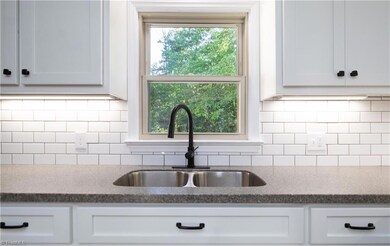 Kitchen sink faces rear of the home