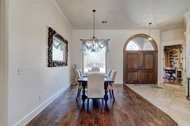 Tiled dining area with an inviting chandelier, orn
