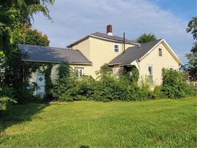 View of side of property with a lawn