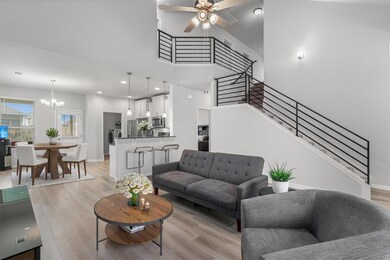 Living area featuring a chandelier, light wood-st