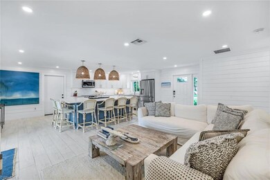 Living room featuring wood walls and light hardwoo