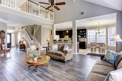 Once inside of the living room, you will immediately be blown away by the drama of the high ceilings and openness of the floor plan, perfect for entertaining or just keeping the conversation going between the cook and those relaxing in the living room.