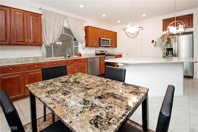 Kitchen with stainless steel appliances, light sto