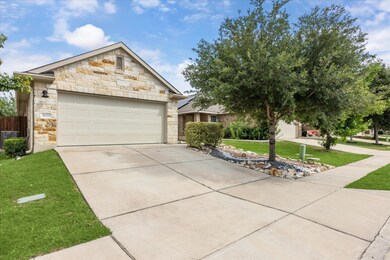 View of front of home featuring stone siding, dri
