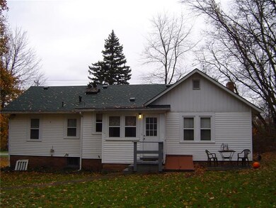 Back view of home shows the outside basement entra