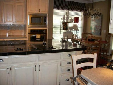 Another picture of the other half of kitchen. Lots of room for meal preperation whether you're a novice cook or a gourmet chef, it doesn't matter with all this counter space you have room for whatever your preference. Convenient eat-in area too!