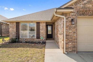Property entrance featuring a lawn, brick siding, 