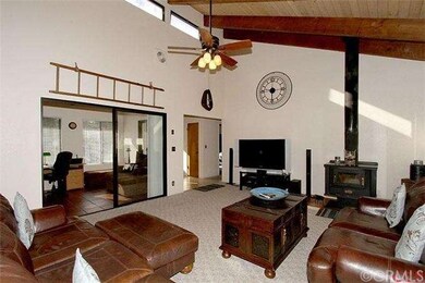 Living room facing entry with tiled solarium. Prev
