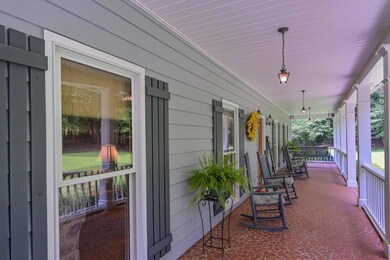 THIS PORCH IS SO LARGE AND HAS A PORCH SWING AT EACH END OF THE PORCH.
