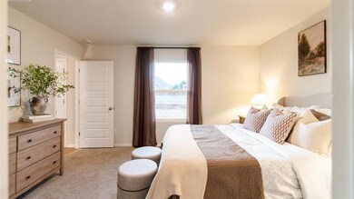Bedroom with light carpet and baseboards