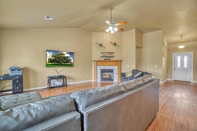 Living room with wood-type flooring, ceiling fan, 