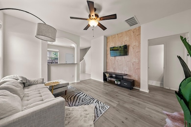 Living area featuring ceiling fan, wood finished 