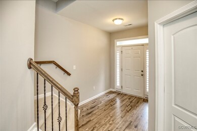 Foyer entrance with wood-type flooring