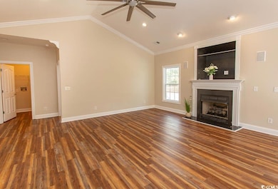 Unfurnished living room with lofted ceiling, ornam