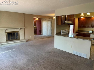 Kitchen with white appliances, dark brown cabinetr