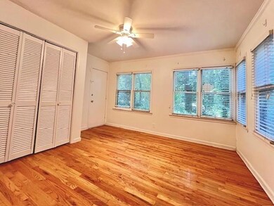 Unfurnished bedroom with light wood-style flooring, a closet, ornamental molding, and a ceiling fan