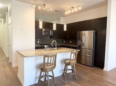 Kitchen with a sink, backsplash, appliances with 