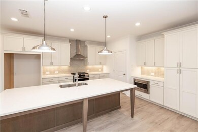Stainless appliances include gas stove, venthood, 