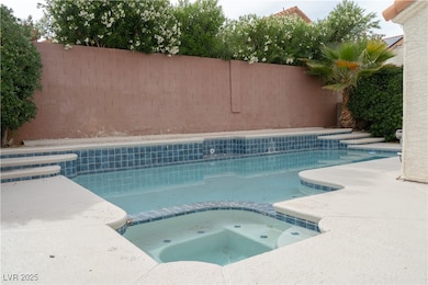 View of swimming pool with fence and a pool with c