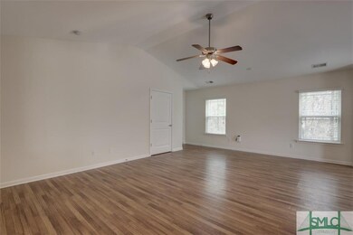 Living room with tall ceilings and hardwood floors