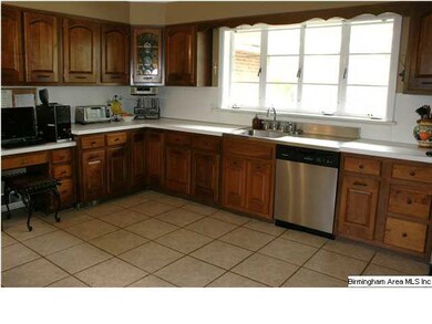 The kitchen features a gas cooktop and double oven