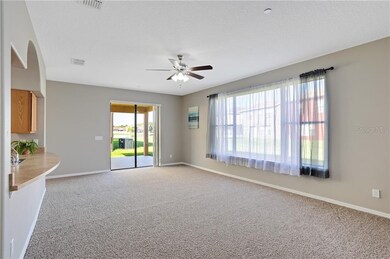 Family room features three glass sliders to courty