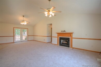 Family room is open to the kitchen with vaulted ce