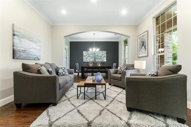 Formal living and dining space is cohesive and perfect for entertaining