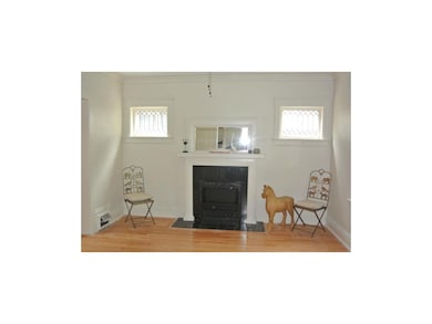 Living room has beautiful hardwoods, leaded glass 