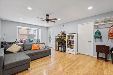 Living room with a ceiling fan, recessed lighting, and light wood-style flooring