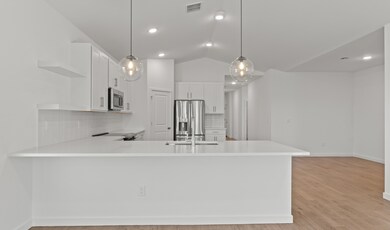 Kitchen with sleek pendant lighting & floating shelves