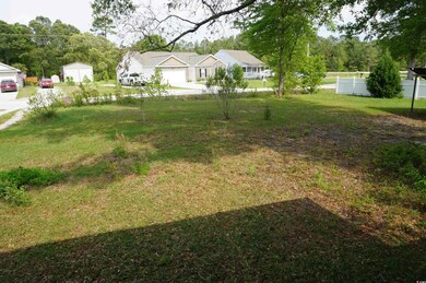 View of yard featuring fence and a garage