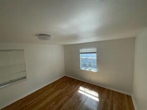 Empty room featuring dark wood-style flooring and