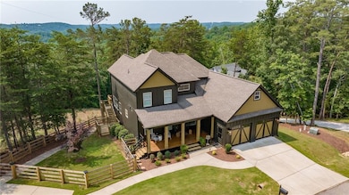 View of front of house featuring a porch, a view of trees, driveway, roof with shingles, and stairs