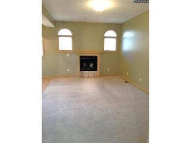 Two windows flank the gas fireplace in the great r