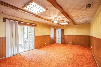 Unfurnished room featuring wainscoting, visible ve