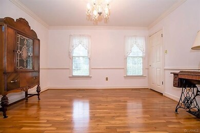 Formal dining room w/ hardwood floors, chair & cro