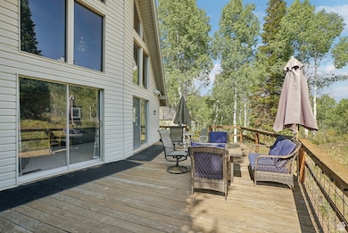 Wooden terrace with view of wooded area