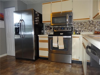 Updated kitchen with stainless appliances and tile