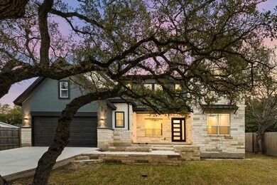 View of front facade with stone siding and drivew