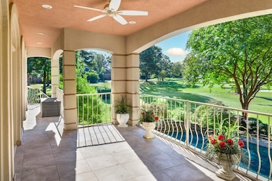 Balcony with a ceiling fan and view of golf course