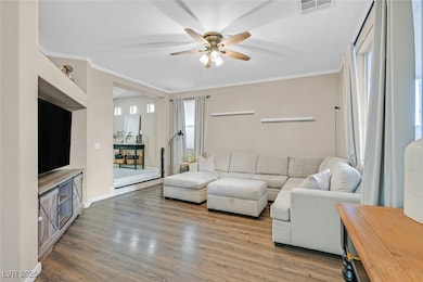 Living room featuring ornamental molding, wood fin